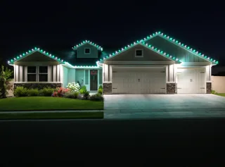A house at night with green and cool white lights along the roof lines and over the garage
